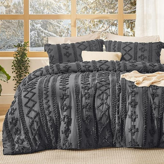 Dark grey tufted boho bedding on a made bed