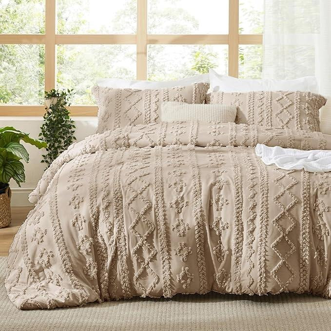 Khaki tufted boho bedding on a made bed